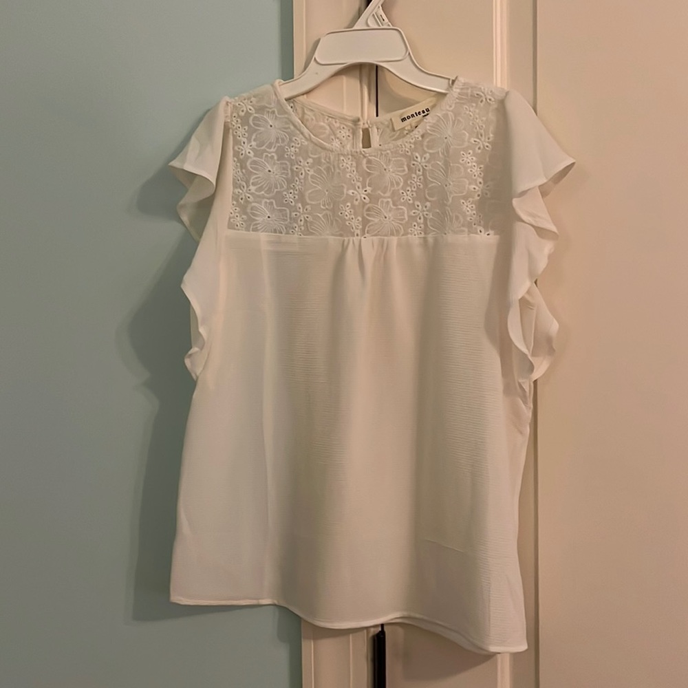 white blouse with ruffle shoulders